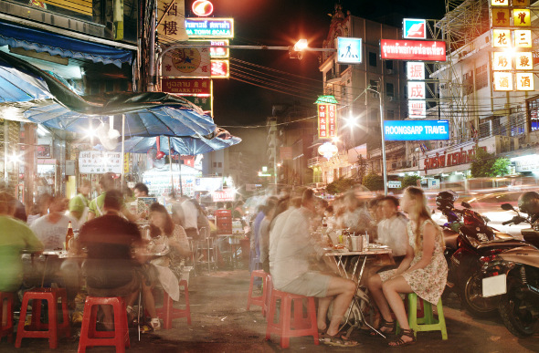 People dining in Bangkok's Chinatown at streetside stalls