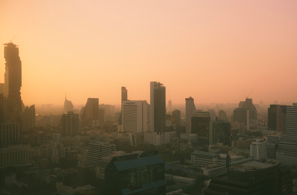 A panoramic shot of the Bangkok cityscape at sunset