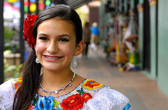 A young female singer in traditional Mexican dress at San Antonio's Market Square