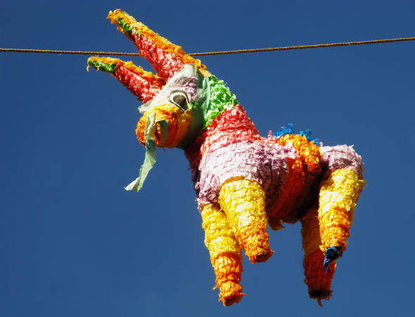 A colourful pinata of a donkey hangs in the sky. This is a popular pastime for Cinco de Mayo celebrations