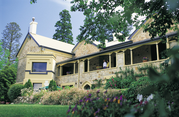 The restored Mt Lofty House with garden and trees