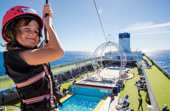 A kid zip-lining on a cruise ship