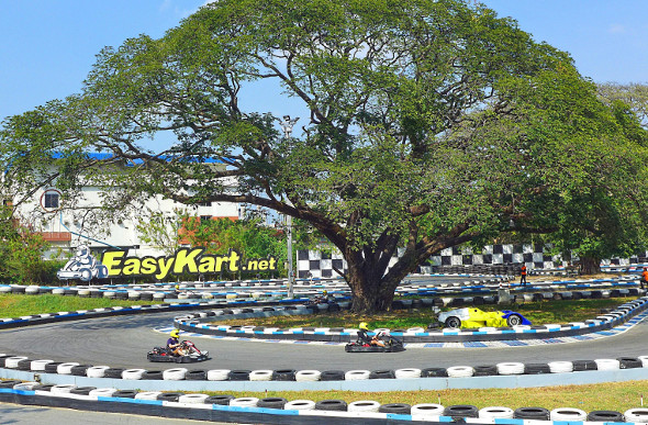 Children racing go-karts around a track