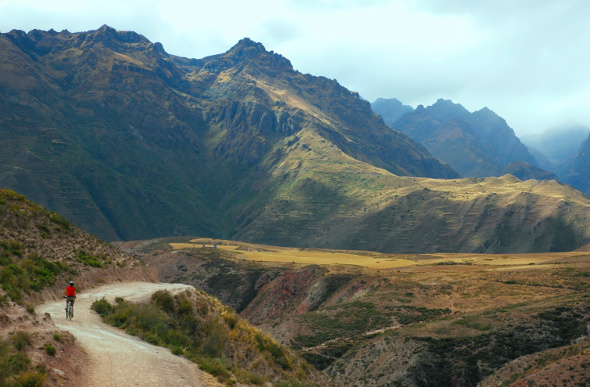 A lone mountain biker rides through the Sacred Valley of Peru. 