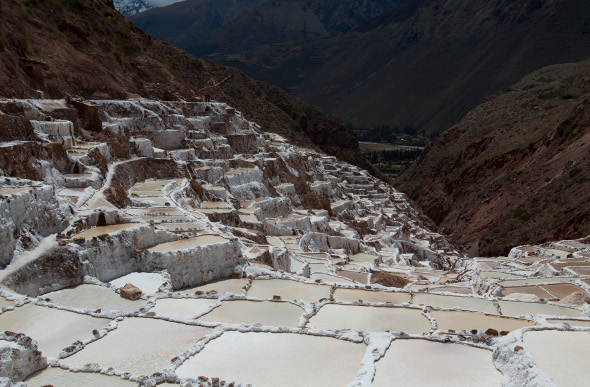 The salt mines of Maras cascade down a hillside in the Andes Mountains of Peru.