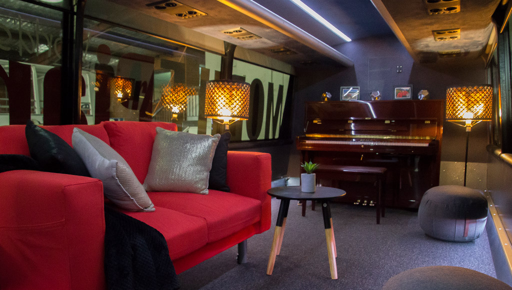 A look inside the AAT Kings travelling piano bar complete with lounge, ottomans and ambient lighting.