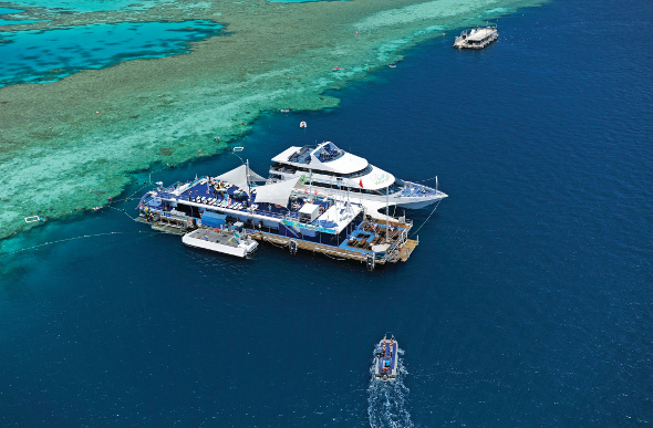 An aerial view of the Reefworld pontoon in the Whitsundays, sitting on the edge of Hardy Reef.