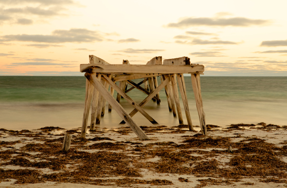 A decrepit jetty jutting out over the ocean