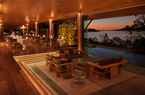 The Long Pavilion at qualia set up for dining as the sun sets over the Whitsundays.