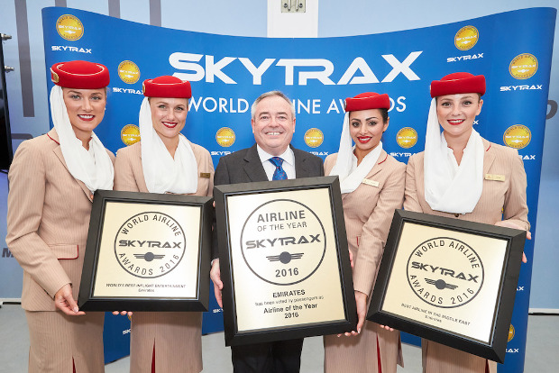 Emirates flight attendants and president holding their awards up at the Skytrax awards