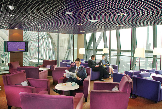 A view of the seating area available at one of Thai Airways' lounges with seated travellers relaxing before their flight